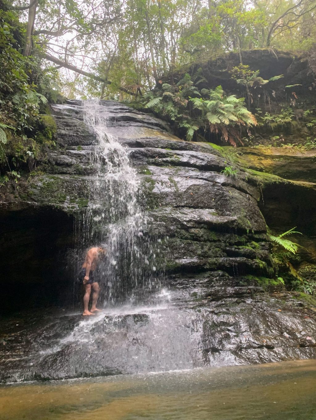 Swimming under the waterfall at Leura Cascades, Blue Mountains National Park NSW