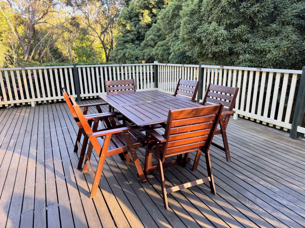Magnolia Cottage Leura outdoor deck with timber dining setting surrounded by Blue Mountains garden